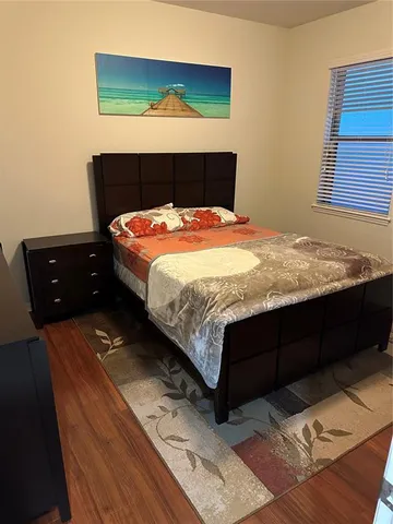 a bedroom with a bed and window