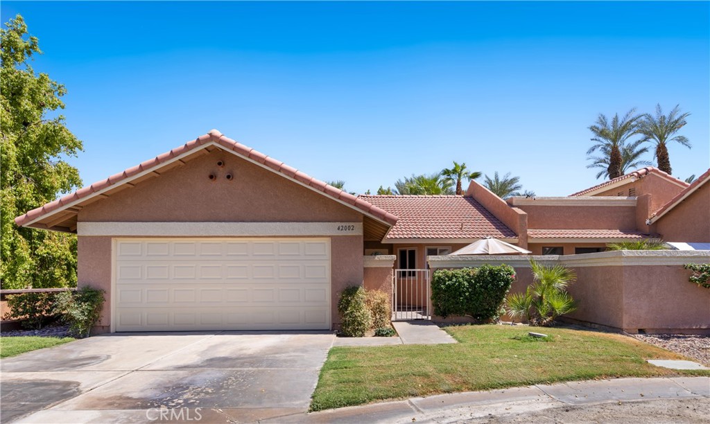 42002 Sand Dune Drive Palm Desert, CA 92211 - Photo 1 of 25 a front view of a house with a yard and garage