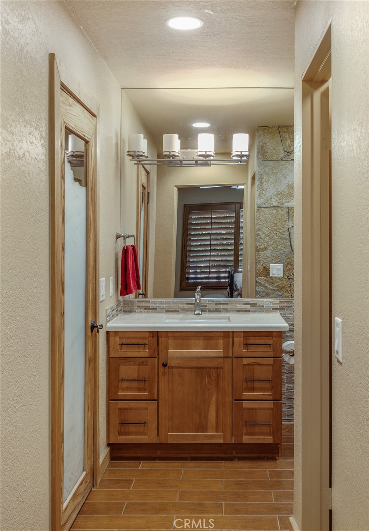 42002 Sand Dune Drive Palm Desert, CA 92211 - Photo 12 of 25 a bathroom with a granite countertop sink and a mirror