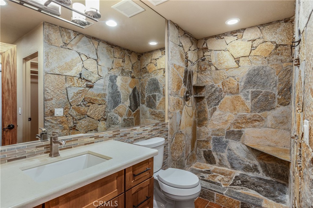 42002 Sand Dune Drive Palm Desert, CA 92211 - Photo 13 of 25 a bathroom with a sink toilet vanity and shower