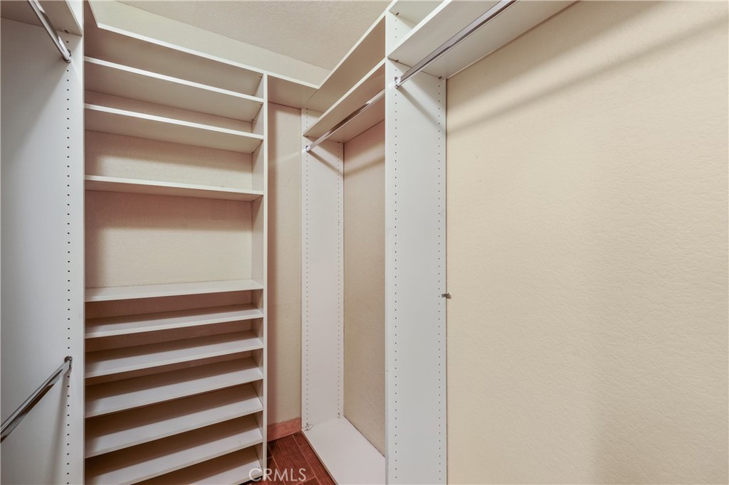 42002 Sand Dune Drive Palm Desert, CA 92211 - Photo 14 of 25 a view of bedroom with wooden floor and closet