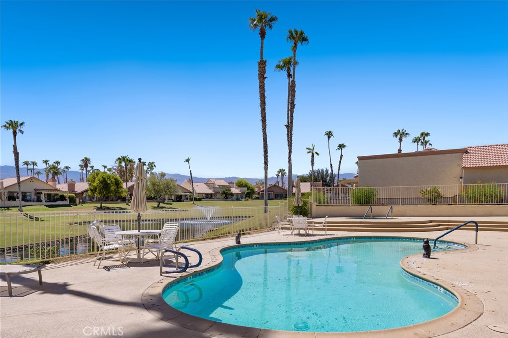 42002 Sand Dune Drive Palm Desert, CA 92211 - Photo 20 of 25 a view of a swimming pool with chairs