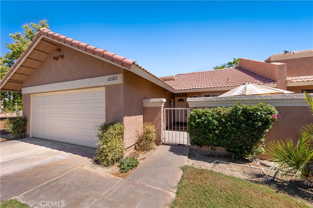 42002 Sand Dune Drive Palm Desert, CA 92211 - Photo 2 of 25 a front view of a house with garden