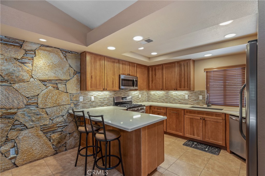 42002 Sand Dune Drive Palm Desert, CA 92211 - Photo 7 of 25 a kitchen with a sink counter top space and stainless steel appliances