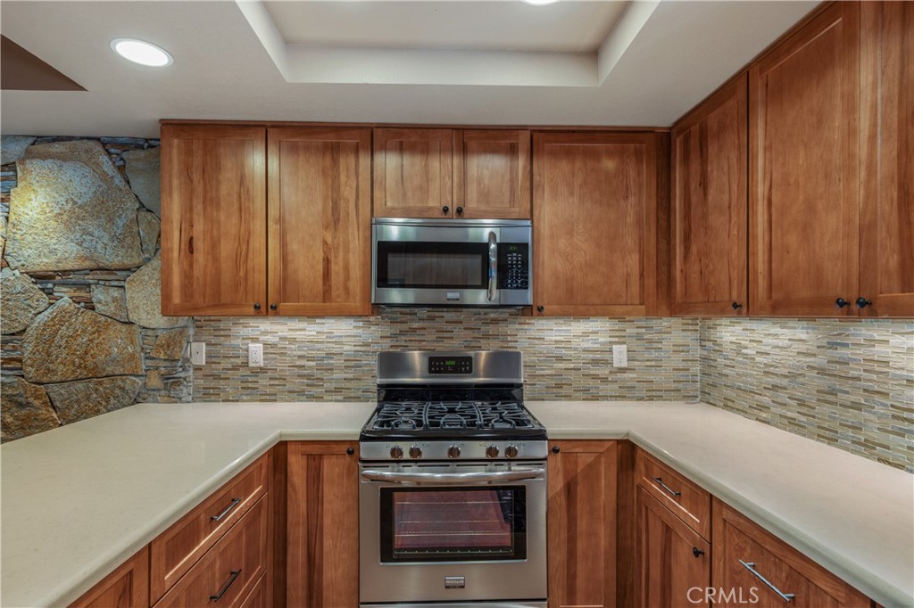 42002 Sand Dune Drive Palm Desert, CA 92211 - Photo 9 of 25 a kitchen with granite countertop a stove sink and cabinets