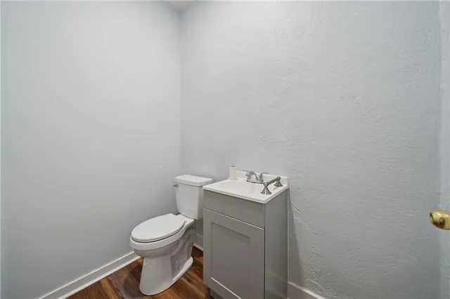 a white toilet sitting next to a white cabinet