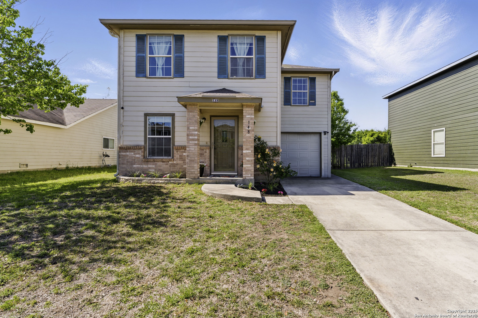 a front view of a house with garden