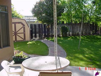 1182 North Reed Avenue Reedley, CA 93654 - Photo 4 of 32 Lovely view of backyard showing nice brick walkway to back gate.