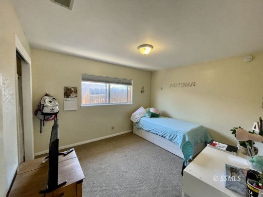 401 South Lincoln Street Ridgecrest, CA 93555 - Photo 12 of 27 a bedroom with furniture and a window