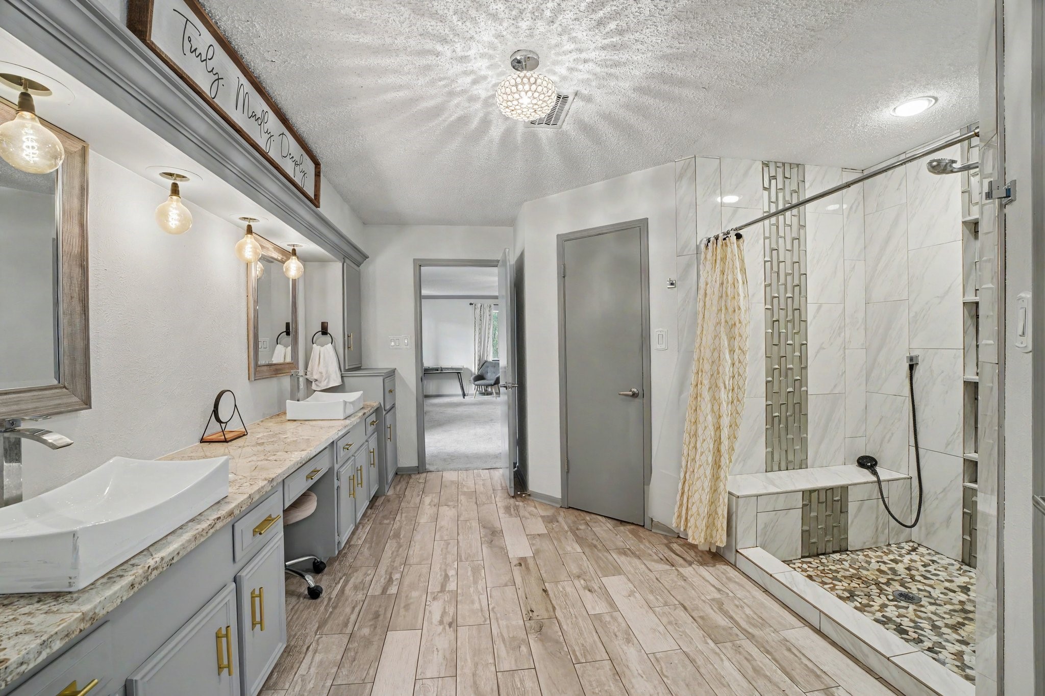 9530 Arcade Drive Spring, TX 77379 - Photo 26 of 32 This primary bathroom also offers dual walk-in closets and a beautiful walk-in shower.