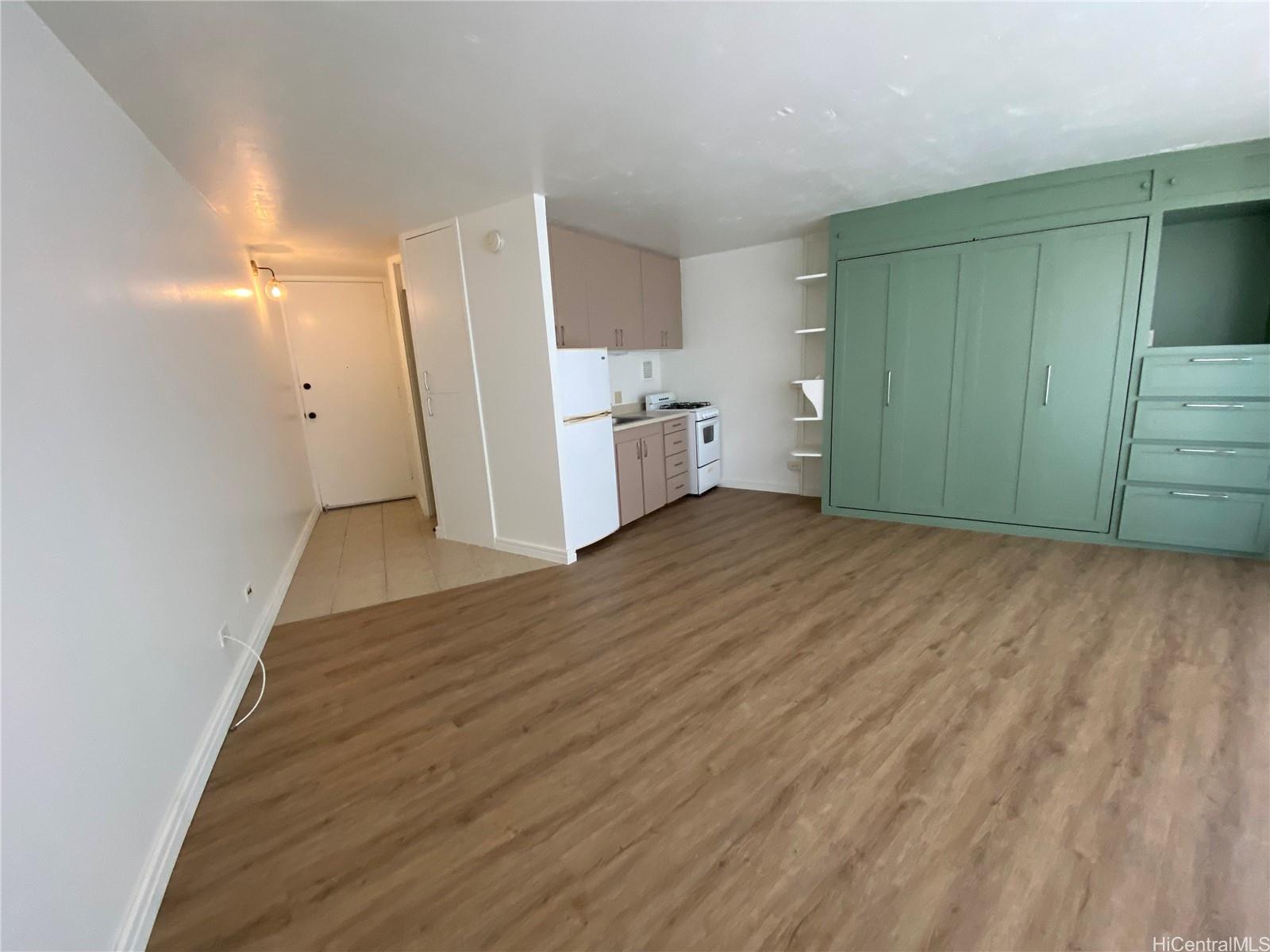 750 Amana Street, Unit 1602 Honolulu, HI 96814 - Photo 5 of 8 a view of a kitchen with wooden floor and electronic appliances
