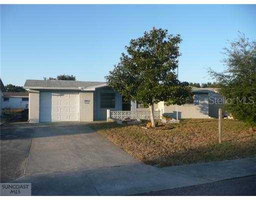 5327 Swallow Drive New Port Richey, FL 34652 - Photo 1 of 1 a front view of a house with a garden and yard