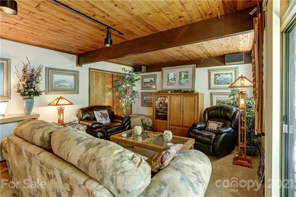 8017 Kiwi Point Tega Cay, SC 29708 - Photo 20 of 43 a living room with furniture a flat screen tv and gym equipment
