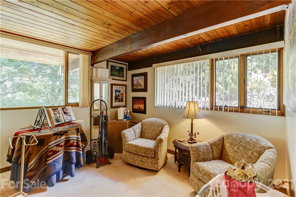 8017 Kiwi Point Tega Cay, SC 29708 - Photo 22 of 43 a living room with furniture and a floor to ceiling window