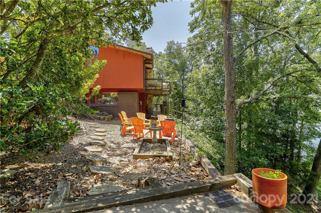 8017 Kiwi Point Tega Cay, SC 29708 - Photo 28 of 43 a view of a backyard with table and chairs and a fire pit