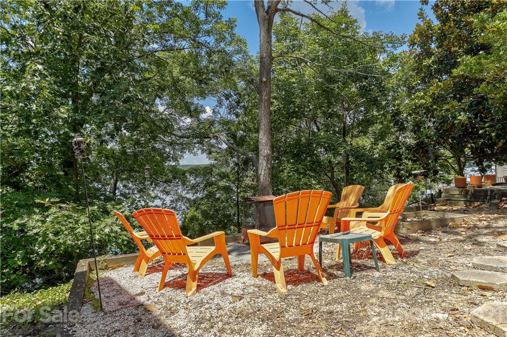 8017 Kiwi Point Tega Cay, SC 29708 - Photo 29 of 43 a couple of blue chairs sitting in backyard of a house