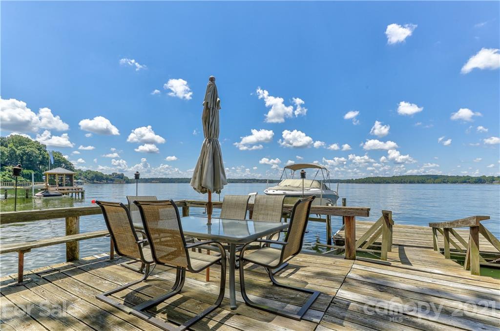 8017 Kiwi Point Tega Cay, SC 29708 - Photo 34 of 43 a view of a lake with table and chairs