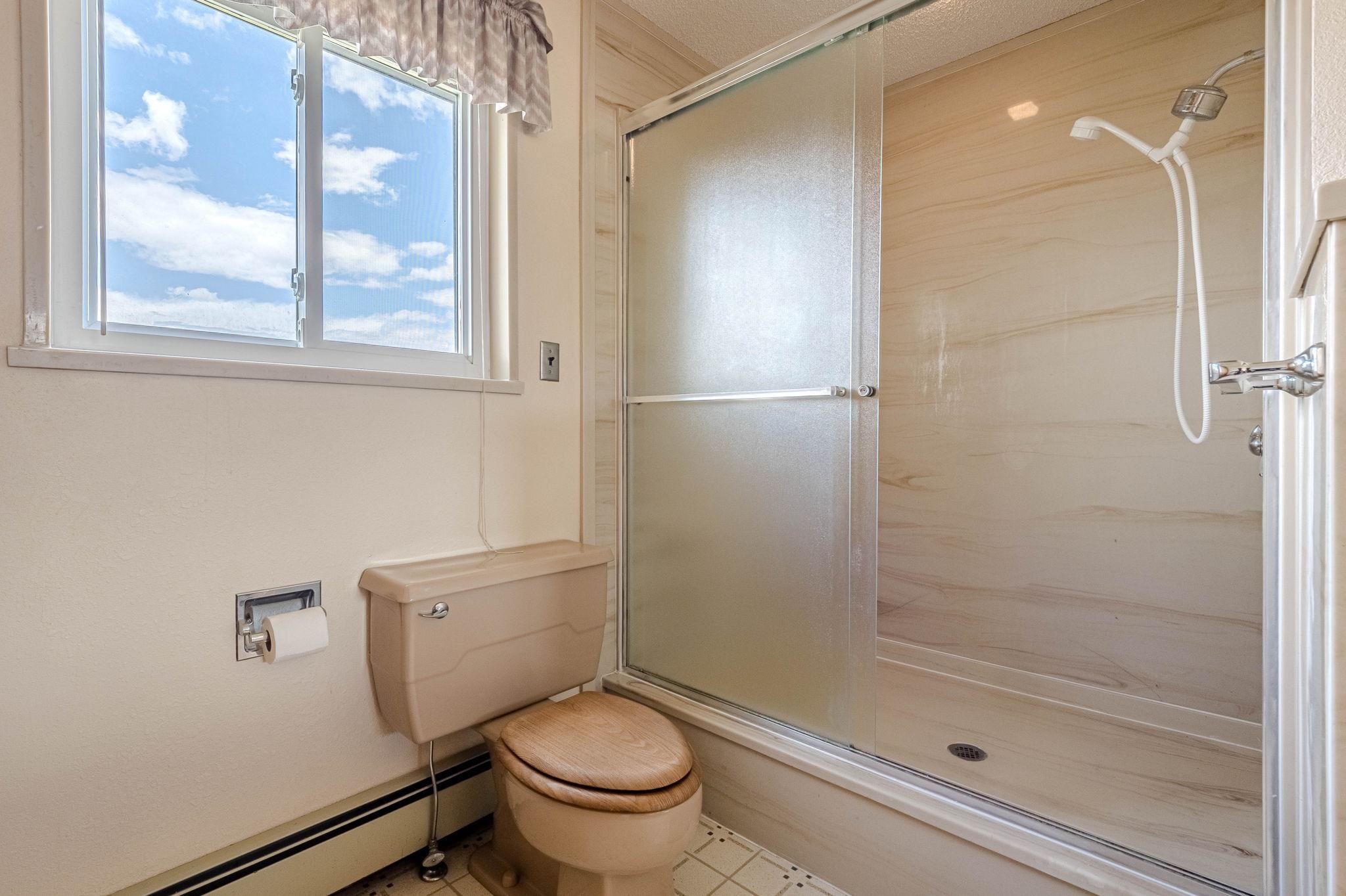 1176-17 17 1/2 Road Fruita, CO 81521 - Photo 25 of 42 a bathroom with a granite countertop toilet a sink and shower