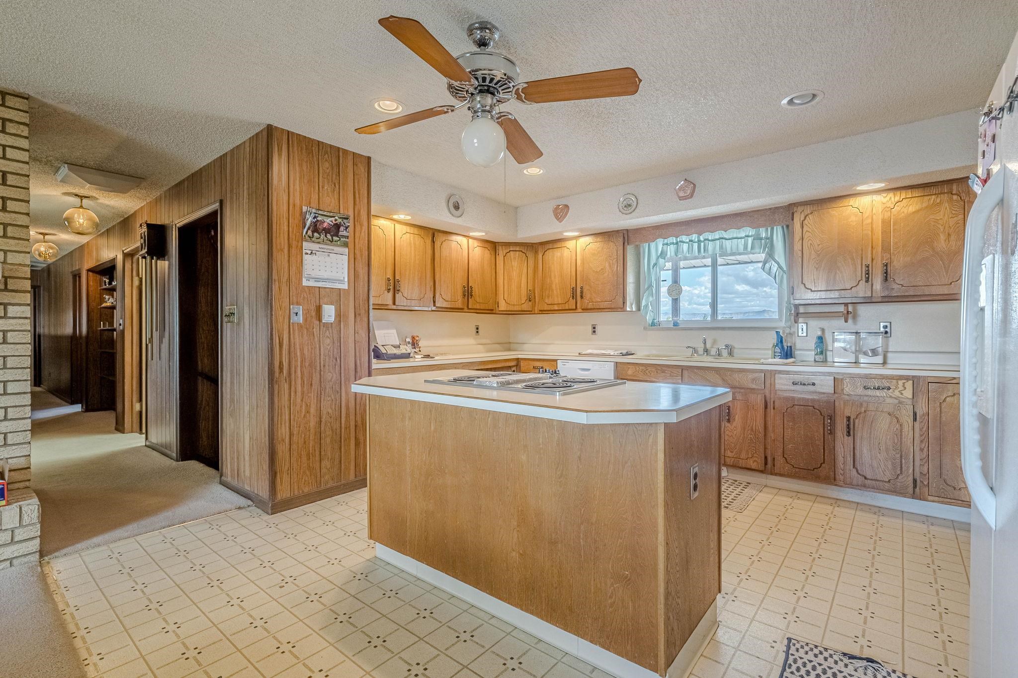 1176-17 17 1/2 Road Fruita, CO 81521 - Photo 27 of 42 a kitchen with kitchen island a counter top space a sink stainless steel appliances and cabinets