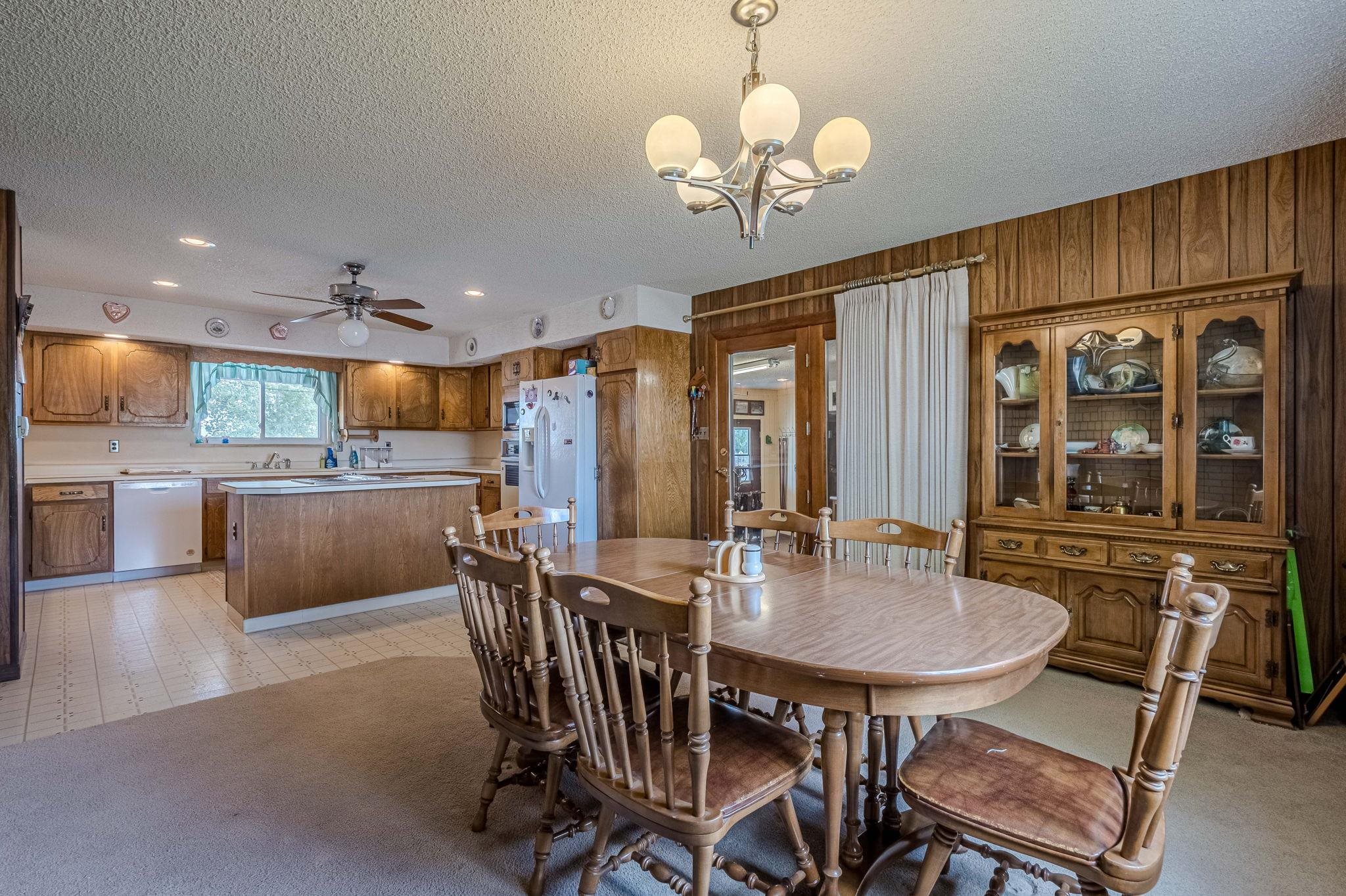 1176-17 17 1/2 Road Fruita, CO 81521 - Photo 31 of 42 a view of a dining room with furniture a chandelier and wooden floor
