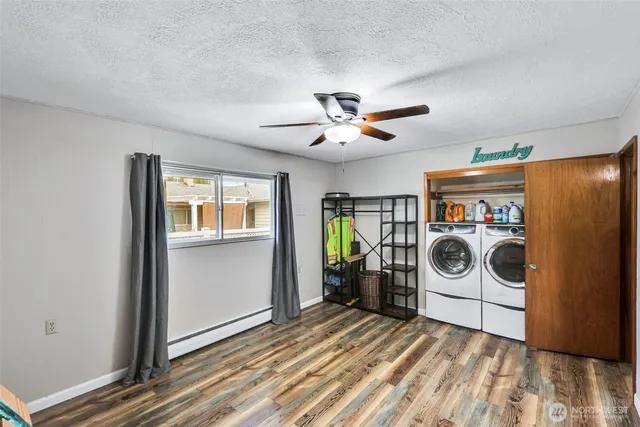 a view of a storage and utility room with washer and dryer