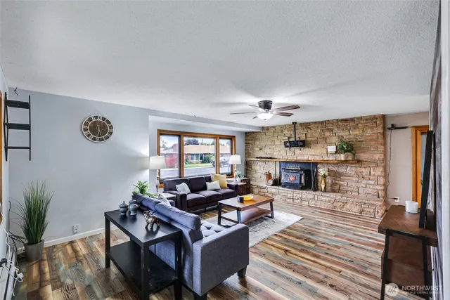 a living room with furniture a fireplace and a table