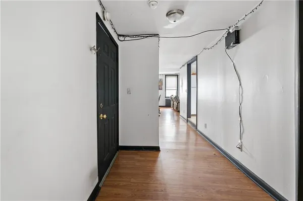 a view of a hallway with wooden floor