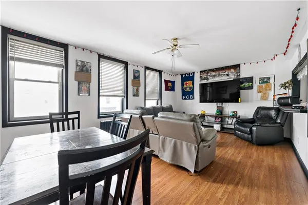 a view of a dining room with furniture window and wooden floor