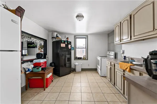 a kitchen with stainless steel appliances granite countertop a refrigerator and a stove