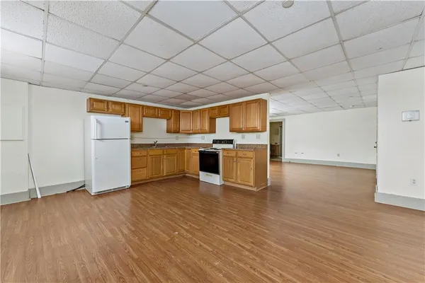 a kitchen with stainless steel appliances wooden floors and wooden cabinets