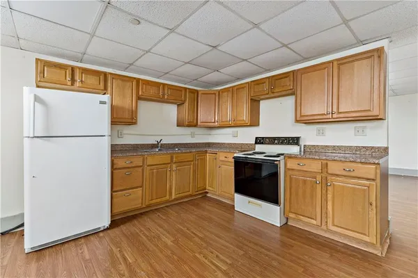 a kitchen with a refrigerator sink and cabinets