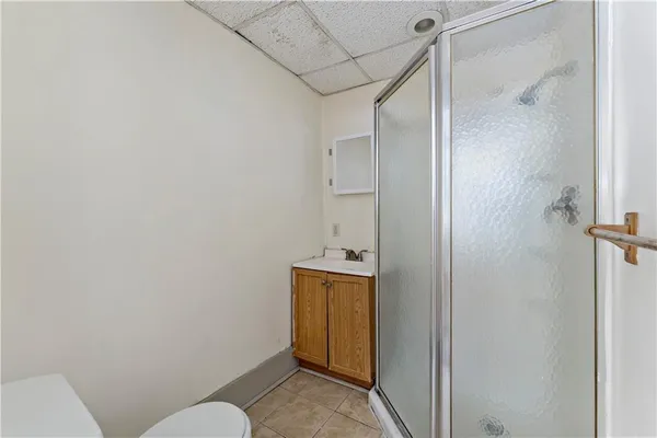 a bathroom with a granite countertop sink and toilet