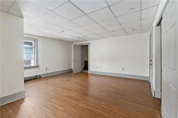 a view of a room with wooden floors