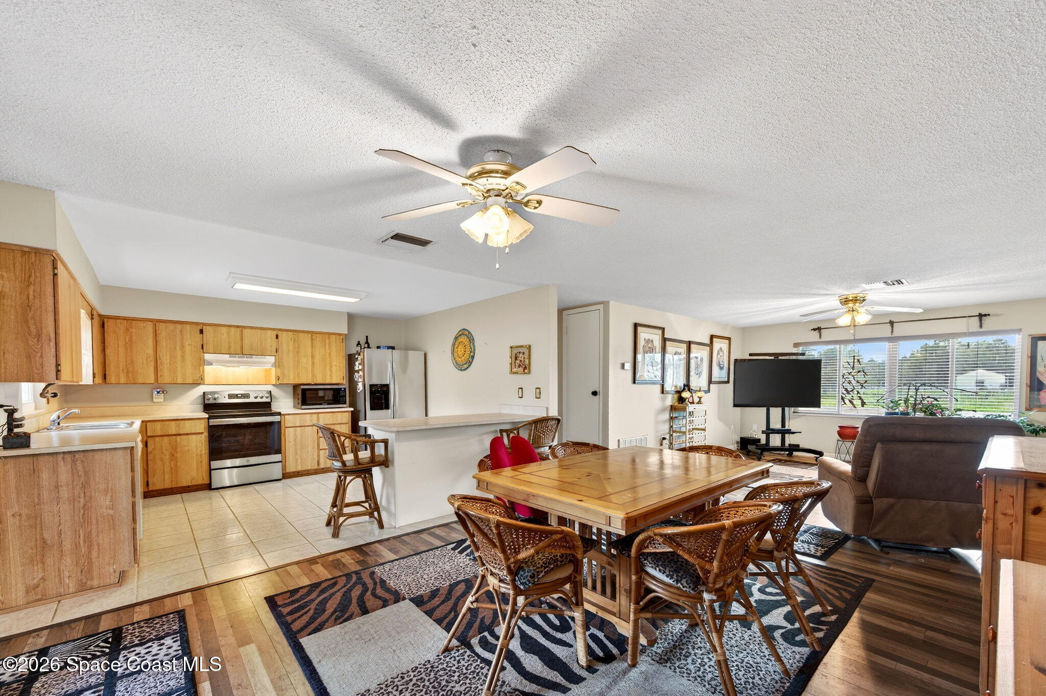 6033 Palm Street Mims, FL 32754 - Photo 11 of 44 a living room with fireplace furniture and a flat screen tv
