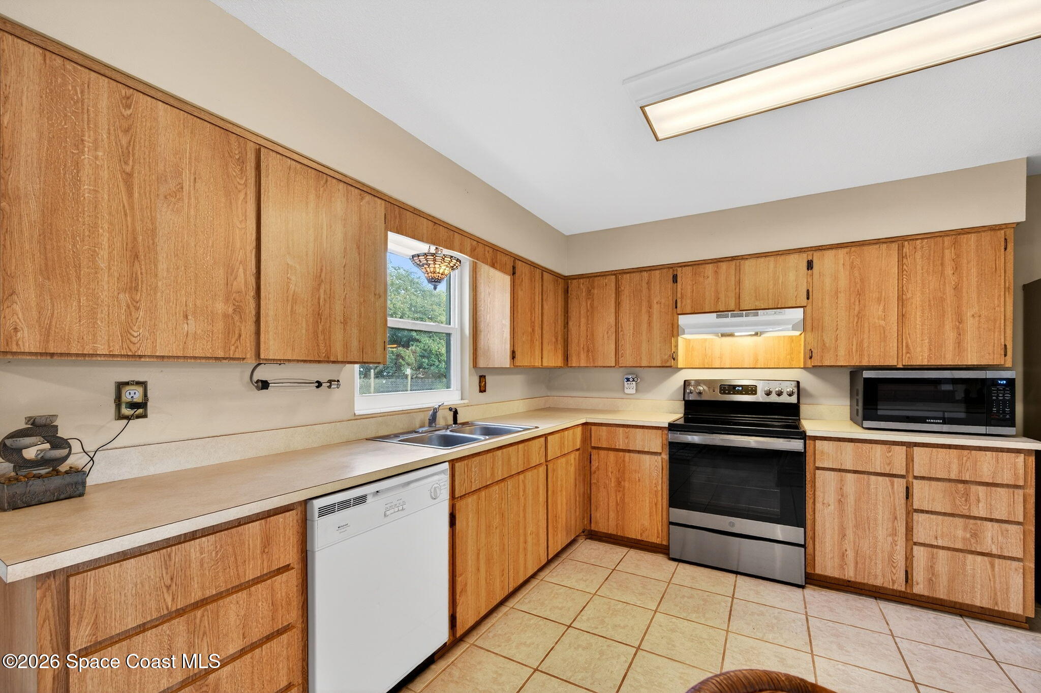 6033 Palm Street Mims, FL 32754 - Photo 15 of 44 a kitchen with a sink stove and cabinets