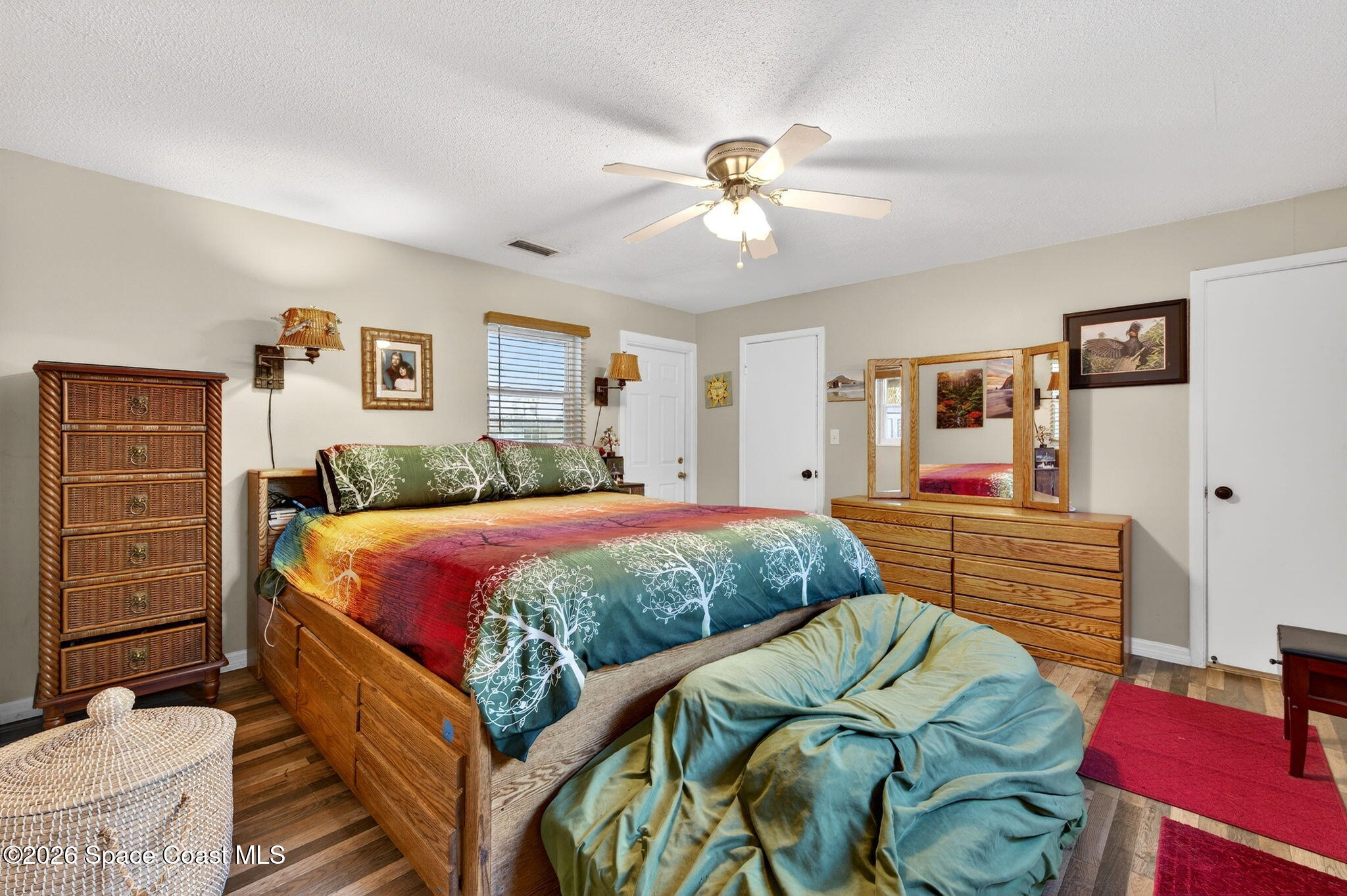 6033 Palm Street Mims, FL 32754 - Photo 19 of 44 a bedroom with a bed and wooden floor