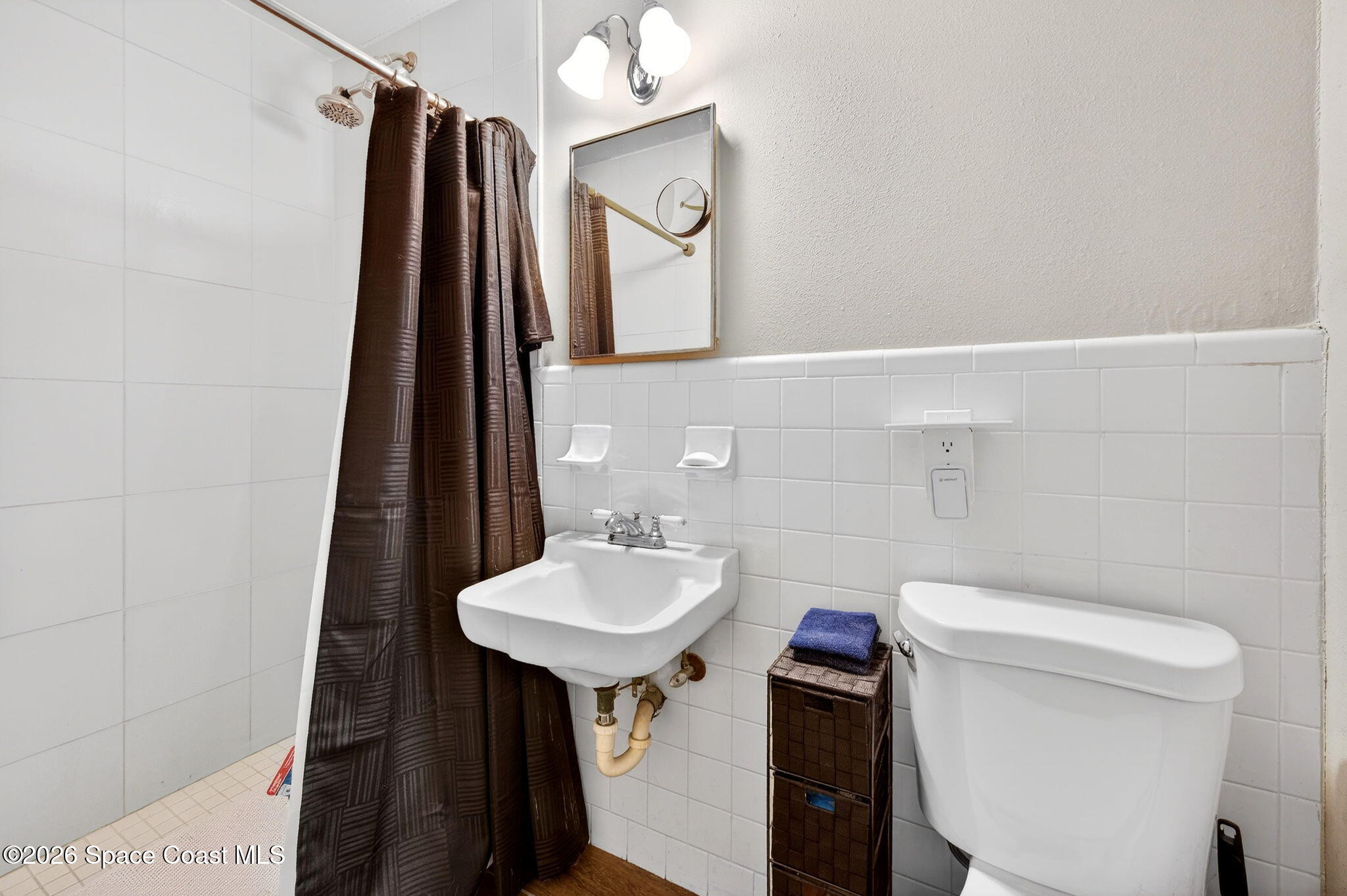 6033 Palm Street Mims, FL 32754 - Photo 22 of 44 a bathroom with a toilet sink and mirror