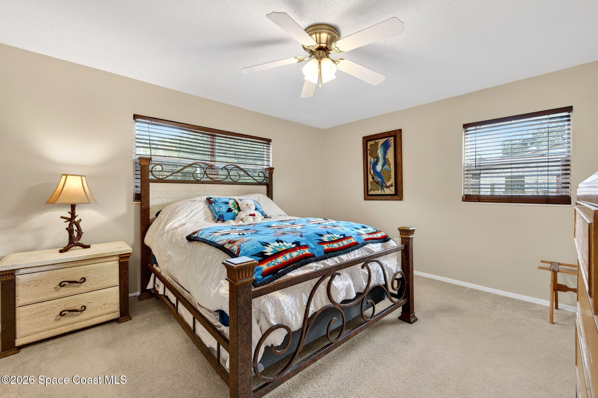 6033 Palm Street Mims, FL 32754 - Photo 24 of 44 a bedroom with a bed and a chandelier