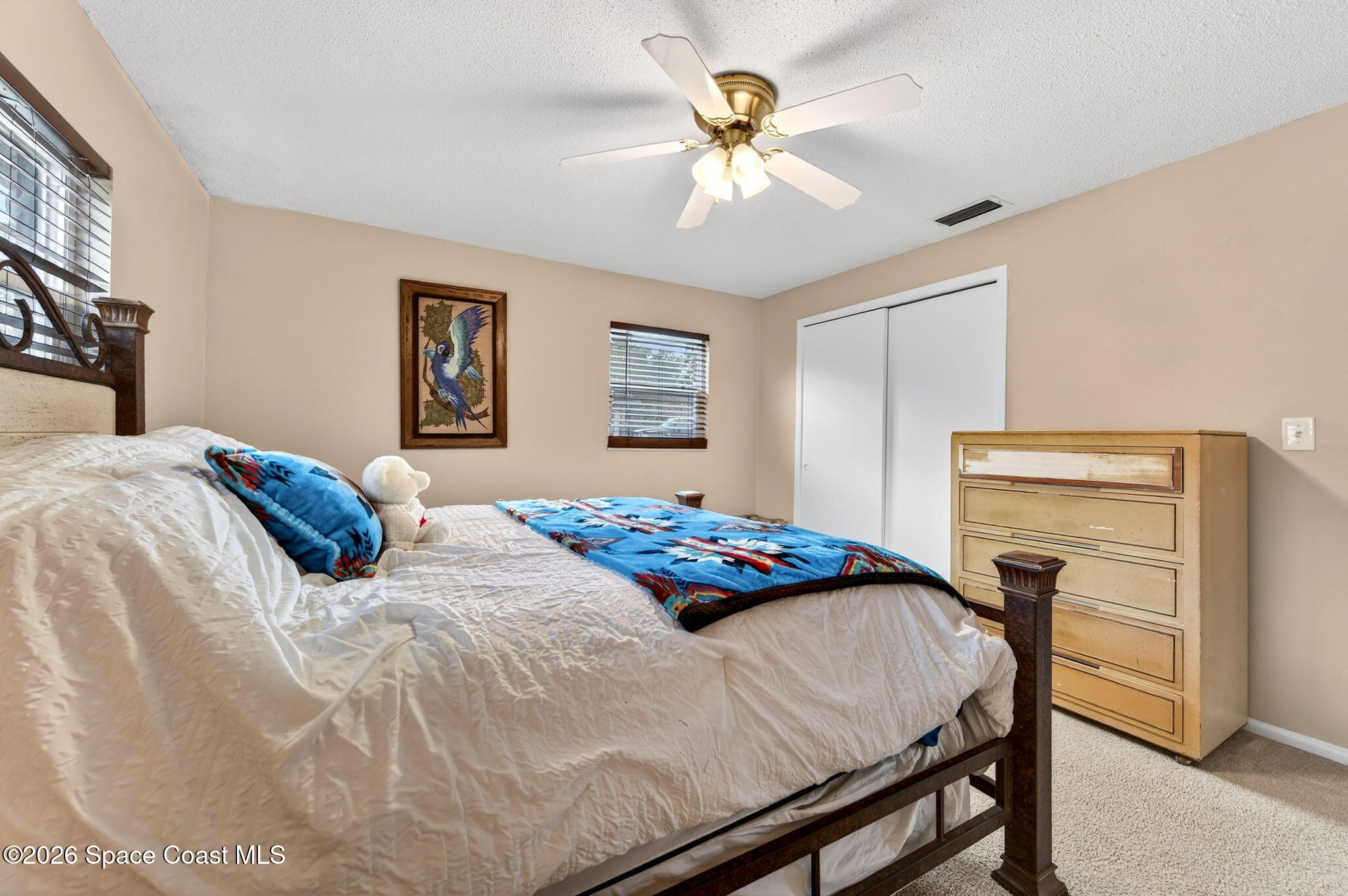 6033 Palm Street Mims, FL 32754 - Photo 25 of 44 a bedroom with a bed and a chandelier