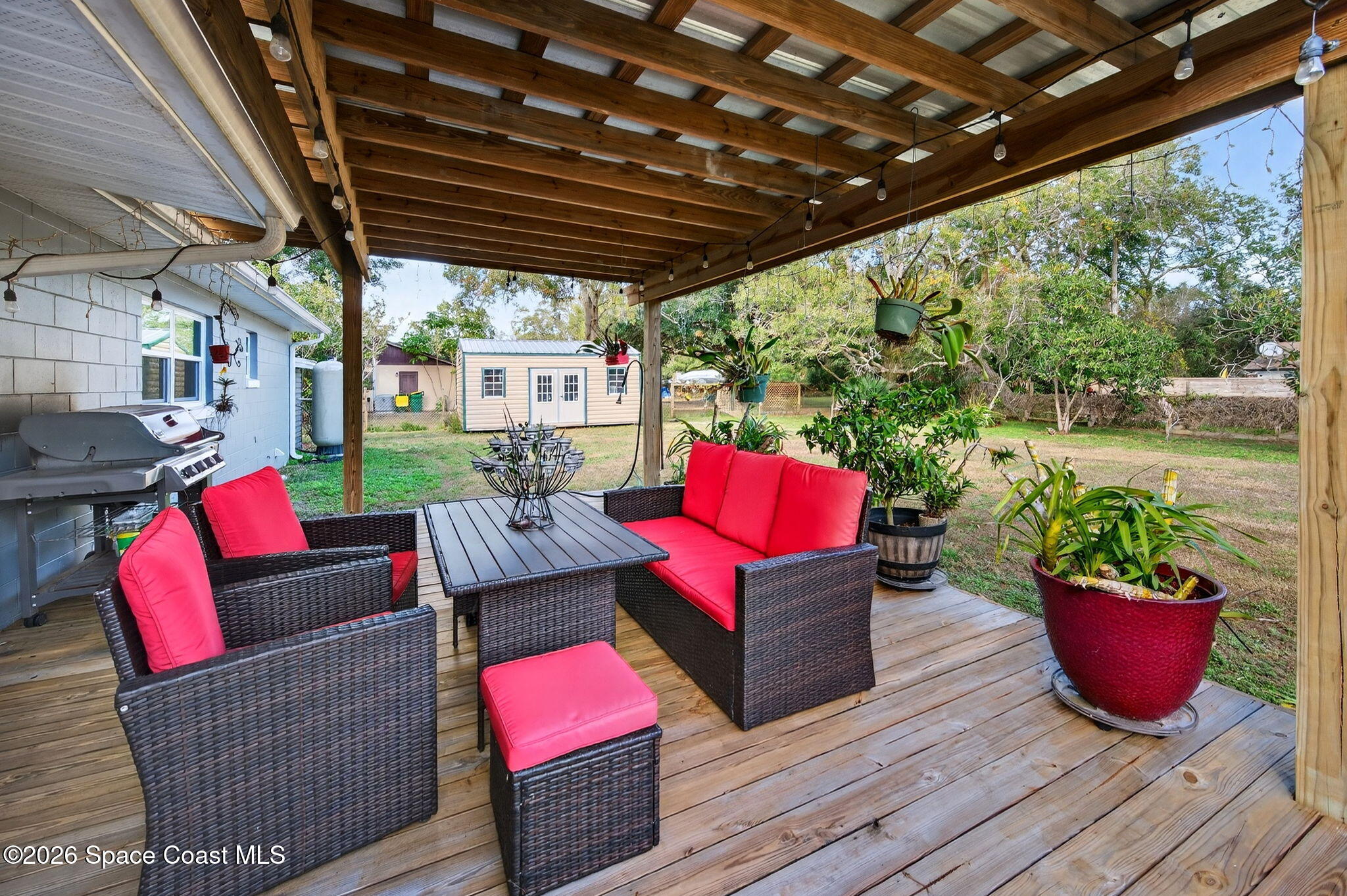 6033 Palm Street Mims, FL 32754 - Photo 29 of 44 a outdoor living space with patio furniture and a potted plant