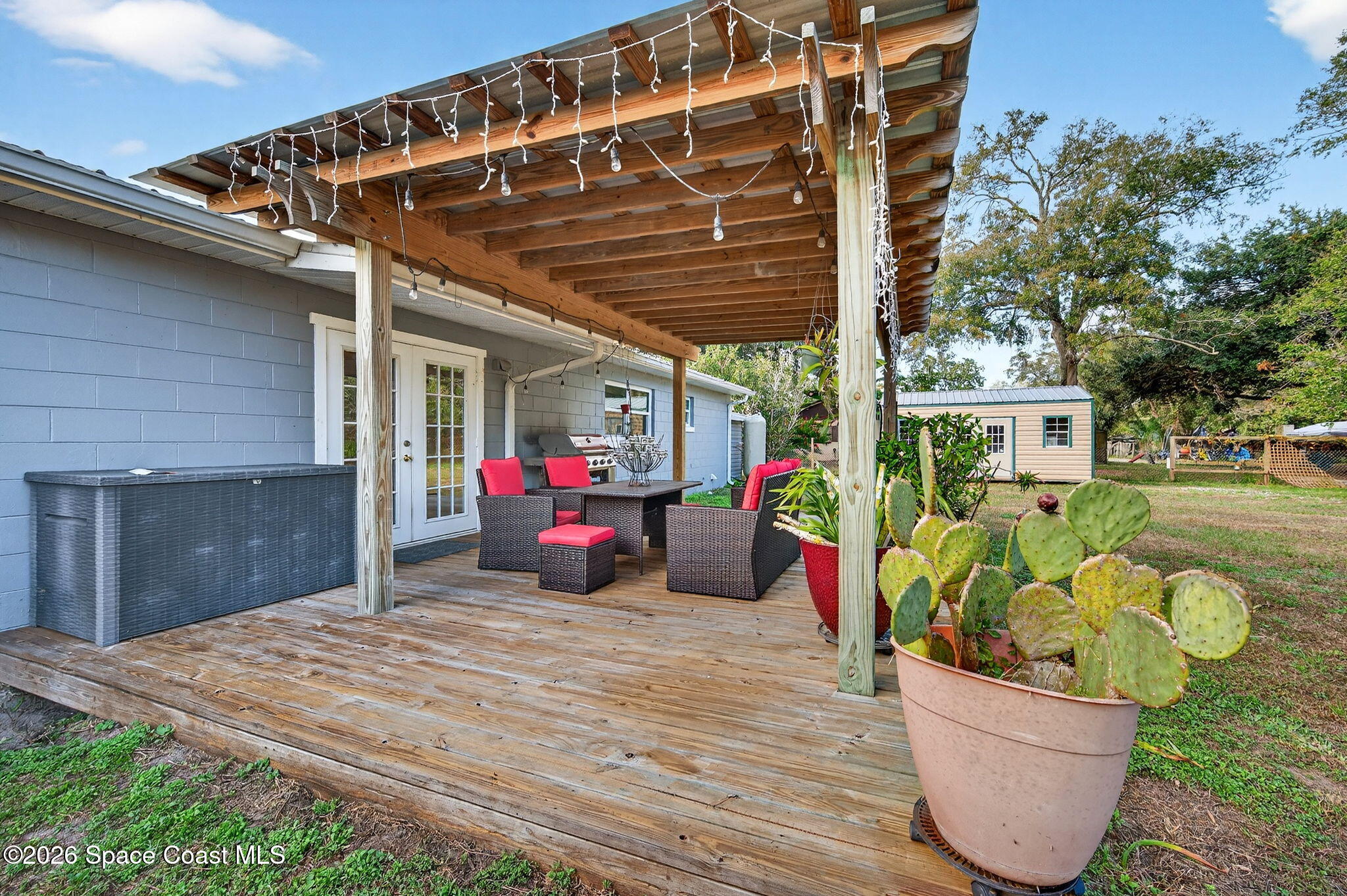 6033 Palm Street Mims, FL 32754 - Photo 30 of 44 a view of a chair and tables in patio of the house