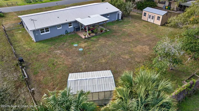 a view of a backyard with plants and outdoor seating