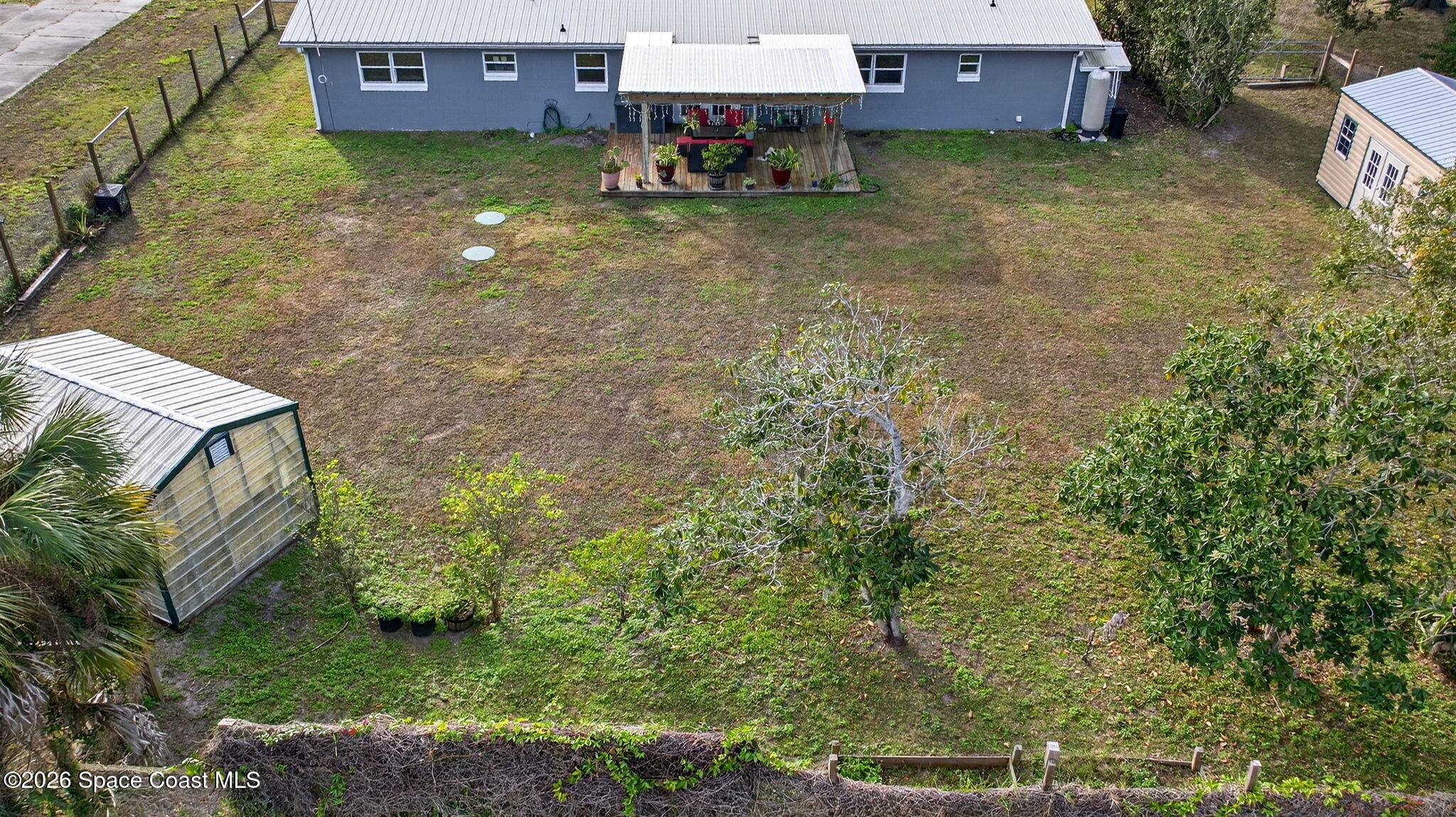 6033 Palm Street Mims, FL 32754 - Photo 41 of 44 an aerial view of a house with a yard