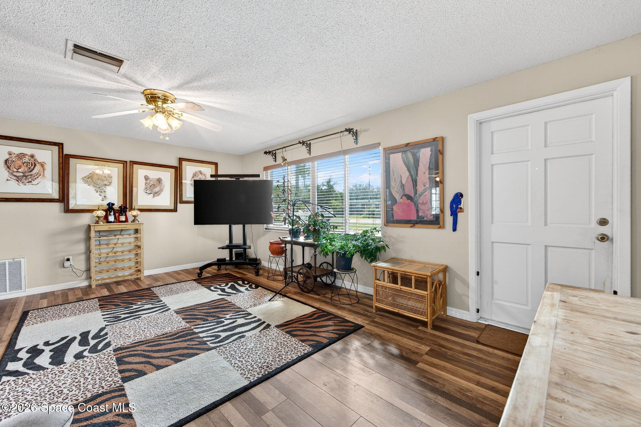 6033 Palm Street Mims, FL 32754 - Photo 5 of 44 a living room with furniture and a flat screen tv