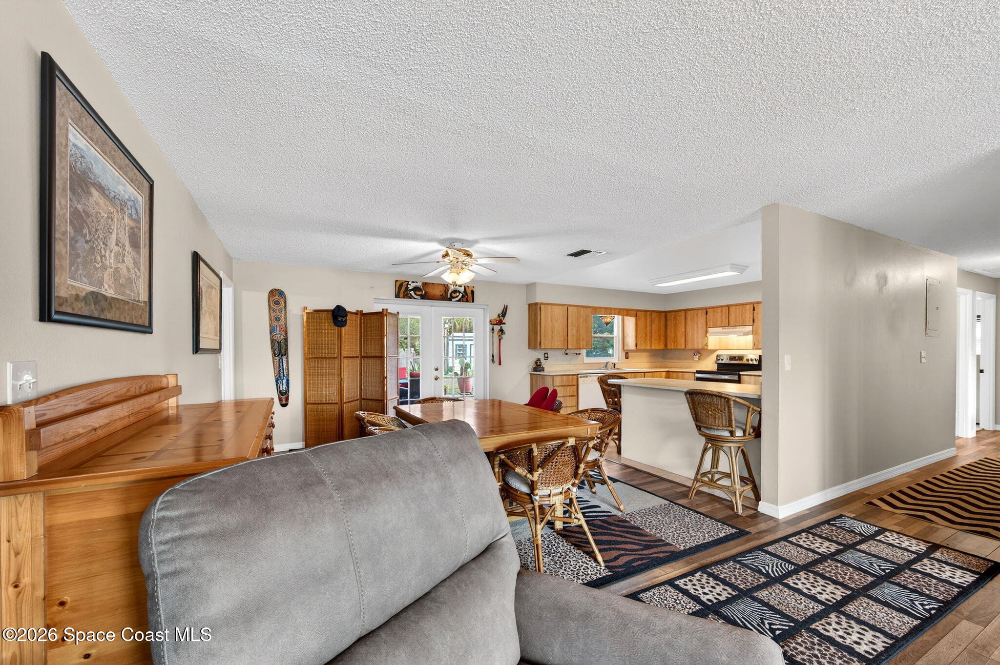 6033 Palm Street Mims, FL 32754 - Photo 10 of 44 a living room with furniture a piano and a flat screen tv