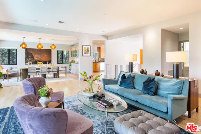 a living room with furniture kitchen and a table