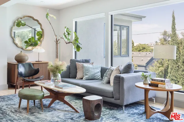 a living room with furniture and a mirror