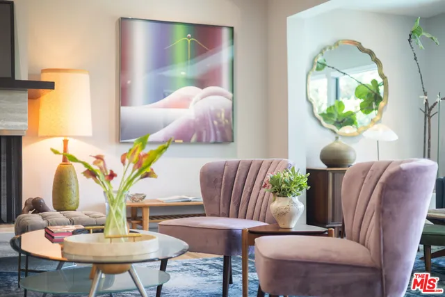 a living room with furniture and a mirror