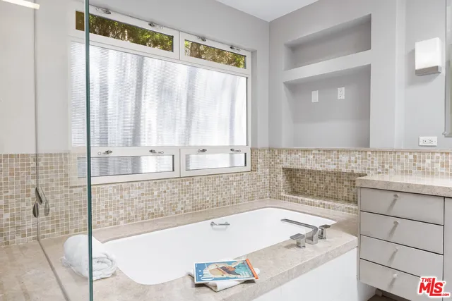 a bathroom with a bathtub and a sink