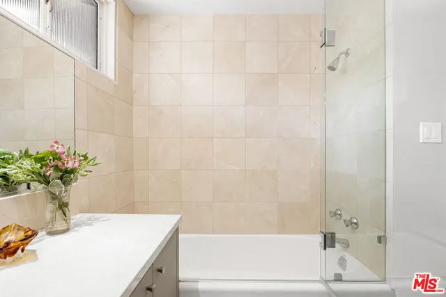 a bathroom with a sink a bathtub and a shower